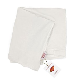 May include: White t-shirt folded with a tag that says "For Cozy Warrior" and a red heart with the word "Warrior" inside.