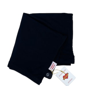 May include: A black, folded, cotton baby wrap with a white tag that says "The Cozy Warrior" and a red heart with the word "Warrior" inside.