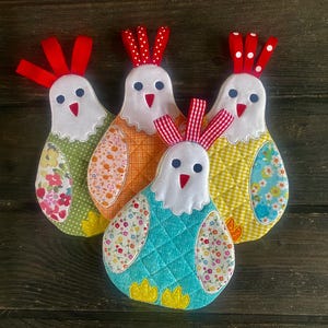 May include: A set of three ceramic mugs with a speckled, matte finish. The mugs are in shades of cream, light brown, and dark brown. Each mug has a simple, minimalist design, perfect for coffee or tea.