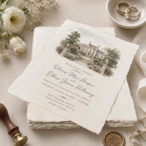 May include: A cream-colored wedding invitation on deckled-edge paper featuring a watercolor illustration of a manor house. The text reads: With joyful hearts, Olivia Mae Harper and Ethan James Holloway request the pleasure of your company.