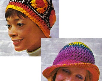 May include: Two women wearing colorful crocheted hats. The first hat is a close-fitting beanie with a geometric pattern in shades of red, orange, yellow, black, and white. The second hat is a wide-brimmed cloche with a gradient pattern in shades of purple, pink, blue, and green.