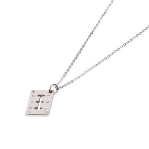 May include: A silver necklace with a square pendant featuring a gear shift pattern. The pendant is about 1 inch wide.