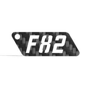May include: A rectangular tag with rounded corners and a hole on the left side. The tag has a black and gray woven pattern. The white text "F82" is centered on the tag.