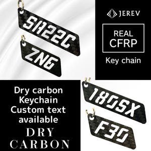 May include: Black dry carbon fiber keychains with white text. The keychains display the text "SA22C", "ZNG", "180SX", and "F30". The image also includes the text "Dry carbon Keychain Custom text available DRY CARBON" and "REAL CFRP Key chain".