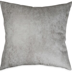 May include: A square decorative pillow with a textured, mottled gray pattern. The pillow has a soft, neutral color palette, with variations of light and dark gray. The pillow is designed for home decor.