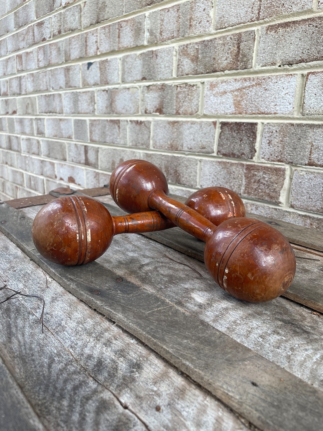 A PAIR OF ANTIQUE WOOD HAND DUMB BELLS 3LB