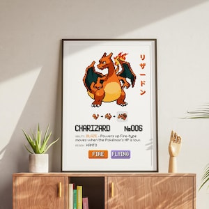 May include: A white framed print of a pixelated illustration of Charizard, a Pokemon character. The print features the character's name, number, and type. The text reads "CHARIZARD No.006 FIRE FLYING".