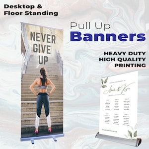 May include: Two pull up banners with metal bases. The left banner displays a person on stairs with the text NEVER GIVE UP. The right banner shows a wedding seating chart with the text Alfredo & Kyrie. Text includes Desktop & Floor Standing.