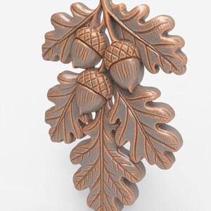 May include: A bronze-coloured decorative piece featuring three acorns and oak leaves. The leaves and acorns have detailed textures and are arranged on a stem. The piece has a metallic finish against a white background.