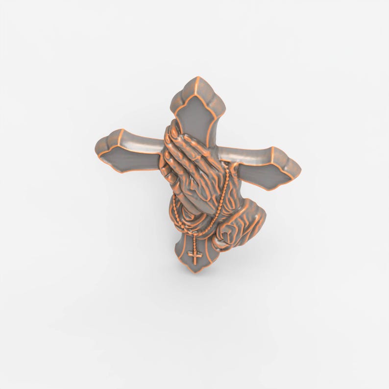 May include: A decorative wall cross featuring a dark gray finish with copper-colored edges. The center of the cross displays a relief sculpture of two hands pressed together in prayer, with a small rosary draped over the hands and a tiny cross.