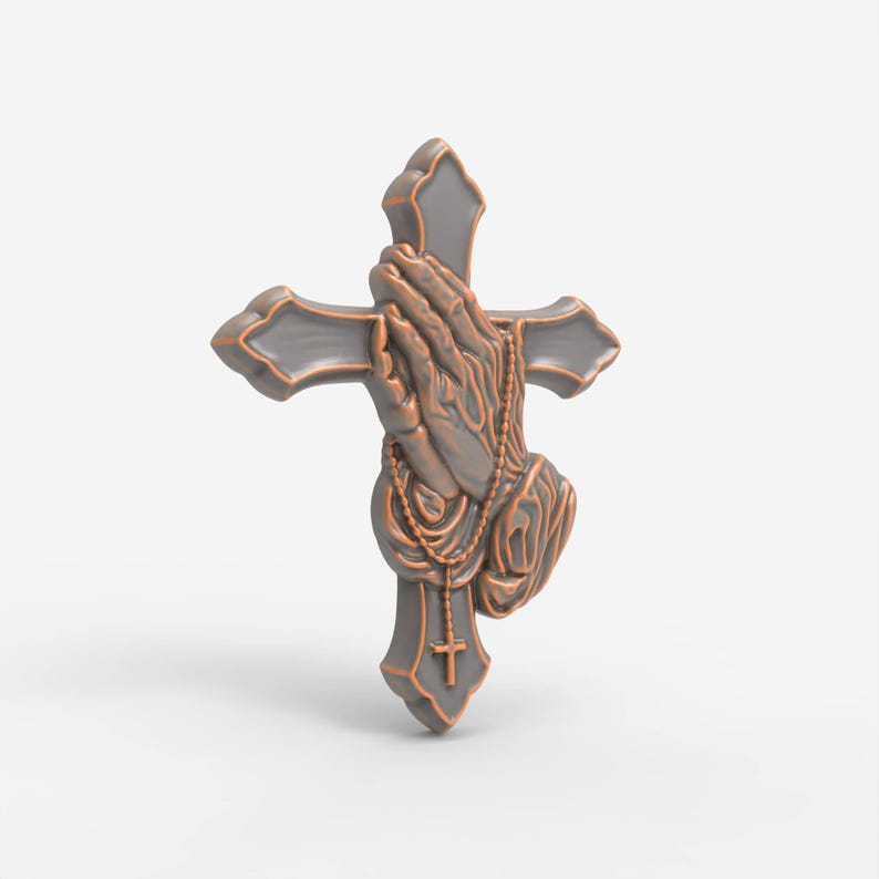 May include: A three-dimensional wall ornament featuring a grey cross with copper-colored edges. The center displays a relief sculpture of two hands pressed together in prayer, draped with a beaded rosary that includes a small cross pendant.