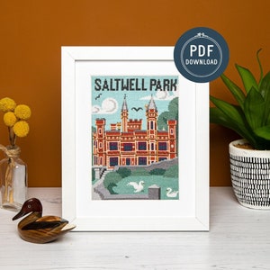 May include: A white framed print featuring the text "Saltwell Park" and a colourful illustration of a castle with a green lawn and swans in front of it.