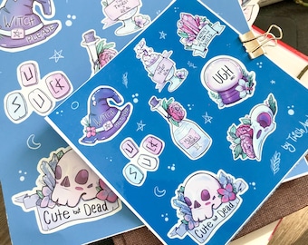May include: Two blue sticker sheets featuring whimsical illustrations. One sheet has a witch hat, the text "Witch Please", and a skull with the text "Cute but Dead". The other sheet has crystal, potion, and other witchy graphics.