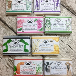 May include: Eight bars of goat milk soap with various scents and ingredients. The soaps are wrapped in paper with illustrations of the scents. The scents include Cedarwood & Rosemary, Lavender, Rose & Geranium, Tea Tree & Thyme, Charcoal & Mint, Honey & Oats, Lemongrass, Grapefruit & Sea Salt, and Unscented.