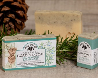 May include: Two bars of goat's milk soap with cedarwood and rosemary scents. The soap is handmade in Shropshire, England. The soap is packaged in a green and white box with a pine cone and rosemary sprig design. The text on the box reads "Pure & Natural Goat's Milk Soap Cedarwood & Rosemary Handmade in Shropshire No SLS. Parabens. Palm Oil. Artificial Fragrances or Synthetic Colours. Cruelty Free."