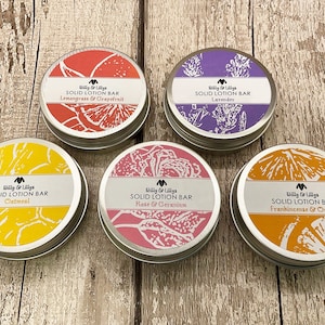 May include: Five round metal tins with lids containing solid lotion bars. The tins are labelled with the brand name "Billy & Lillys" and the scent of each lotion bar: Lemongrass & Grapefruit, Lavender, Oatmeal, Rose & Geranium, and Frankincense & Orange.