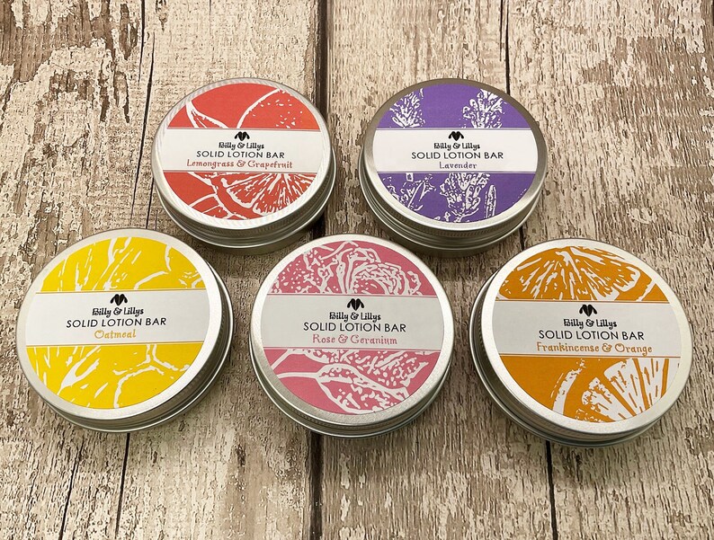 May include: Five round metal tins with lids containing solid lotion bars. The tins are labelled with the brand name "Billy & Lillys" and the scent of each lotion bar: Lemongrass & Grapefruit, Lavender, Oatmeal, Rose & Geranium, and Frankincense & Orange.