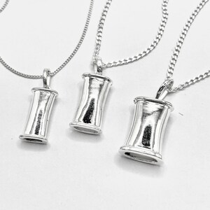 Three sizes of sterling silver breathing pendants on a clean white background.