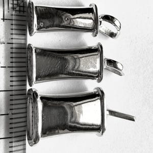 Three breathing pendant widths displayed beside a ruler for size comparison.