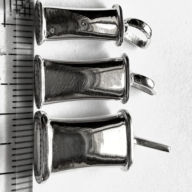 Three breathing pendant widths displayed beside a ruler for size comparison.