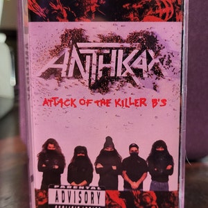 May include: Anthrax "Attack of the Killer B's" cassette tape. The cover features the band members in black clothing, with the album title in red. A parental advisory warning is visible.