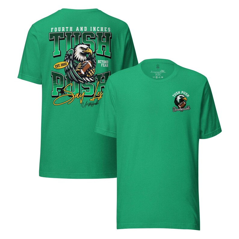 May include: Two green t-shirts with football-themed designs. One has a large graphic on the back with an eagle holding a football, the words "TUSH PUSH", and "Say Yes". The other has a smaller eagle and football graphic on the front with the word "Unstoppable".