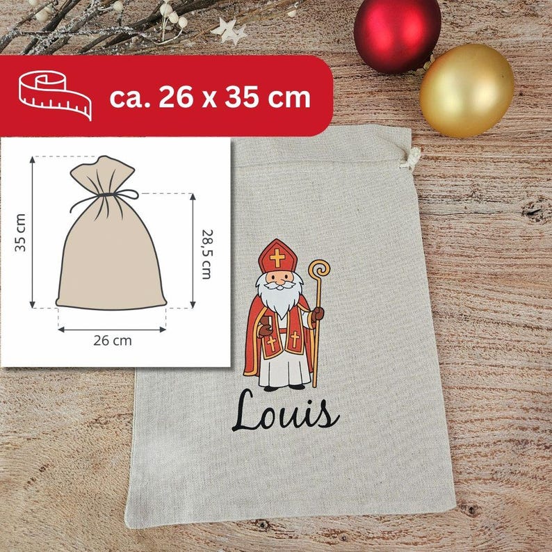 May include: A beige drawstring gift bag with a cartoon illustration of Saint Nicholas in red and white robes, holding a staff. The name "Louis" is printed in black script below the illustration. The bag measures approximately 10.2 x 13.8 inches.