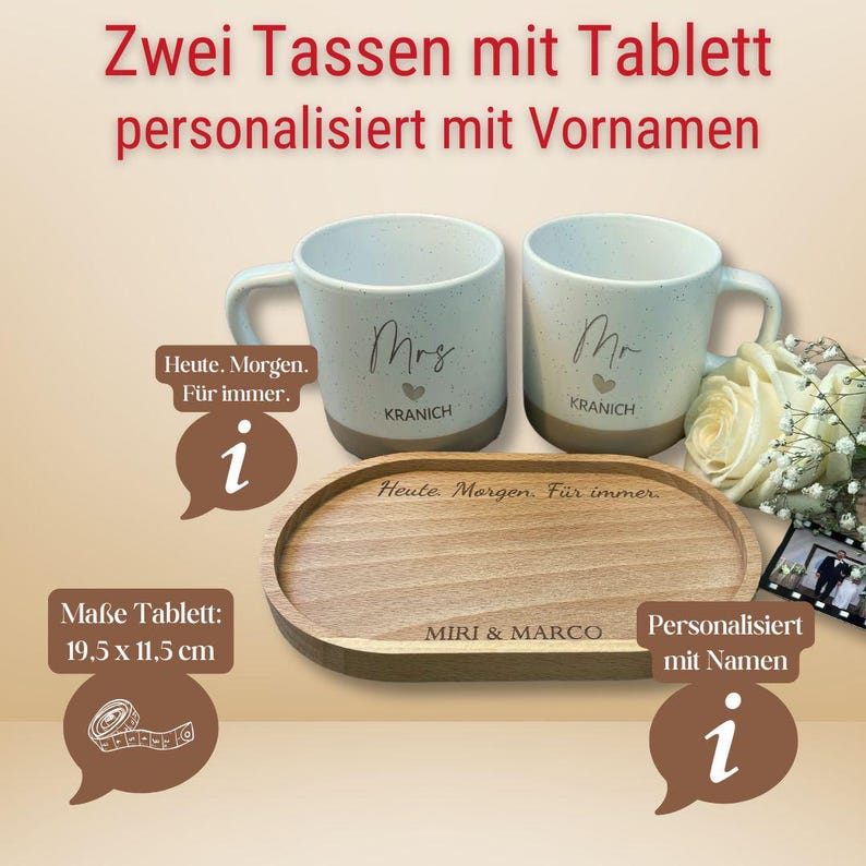 May include: Two speckled ceramic mugs, one labeled "Mrs" and the other "Mr", with the last name "KRANICH" below. They sit on a wooden tray, 19.5 x 11.5 cm, engraved with "MIRI & MARCO" and "Heute Morgen. F&uuml;r immer."