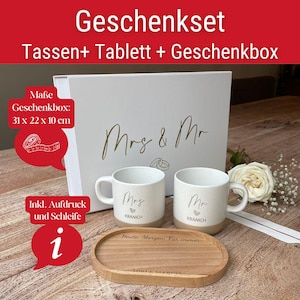 May include: A white gift set with the text "Geschenkset" and "Tassen+ Tablett + Geschenkbox". The set includes two mugs with "Mrs" and "Mr" printed on them, a wooden tray, and a gift box. The box measures 12.2 x 8.7 x 3.9 inches.