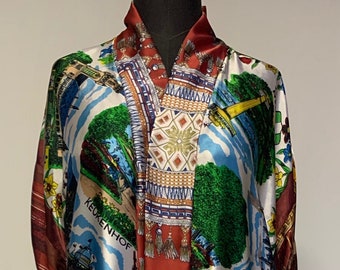 May include: A long, open-front robe featuring a vibrant, multi-colored print of Dutch landscapes, including Keukenhof and Nieuwe Kerk, mixed with autumn leaf patterns. The garment has a central dark red panel with a decorative tassel-like graphic print.