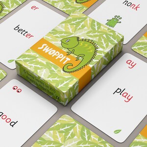 May include: A set of colourful flash cards with green leafy backgrounds and illustrations of a lizard and a monster. The cards feature the words "better", "er", "nonk", "ay", "play", "good", "SWOPPIT", and "Treetop Learning Ltd 2015 Artwork by Abigail Burch CE".