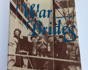 May include: A vintage book cover featuring a sepia-toned photograph of women and children on a ship. The title is "War Brides of World War II" by Elfriede Berthiaume Shukert and Barbara Smith Scibetta. The book cover also includes the text "S.R. Southampton".