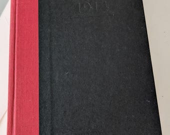 May include: A black hardback book with a red spine. The title "Lynn MacLeod 1911" is embossed on the front cover.