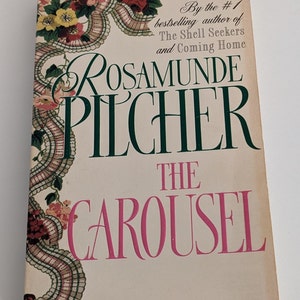 May include: A book cover with a floral design and the title "The Carousel" by Rosamunde Pilcher. The book is by the #1 bestselling author of "The Shell Seekers" and "Coming Home".
