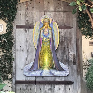 May include: A colorful painting of an angel with a crown and wings, holding a bird in her hands. The angel is standing in a forest with a path leading to a bright light. The painting is on a wooden door.