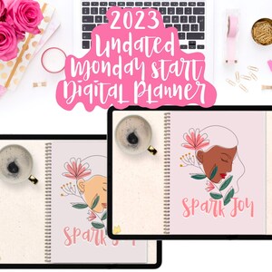 May include: Two digital planners with pink covers and floral designs. The covers feature the text "Spark Joy". The planners are on a white surface with a laptop, coffee cup, and other office supplies.