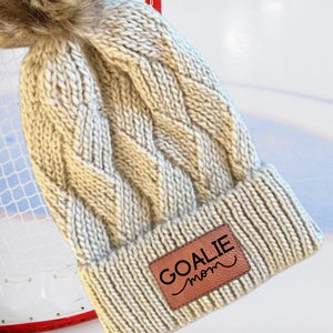 Goalie Mom Winter Beanie Custom Cable Knit Hat Warm Ice Rink Essential Hockey Parent Support Team Spirit Wear Faux Fur Pom Design Cold Weather Sports Gear Perfect Game Day Accessory Personalized Athletic Style Team Pride Collection