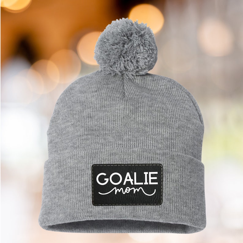 Goalie Mom Winter Beanie Custom Cable Knit Hat Warm Ice Rink Essential Hockey Parent Support Team Spirit Wear Faux Fur Pom Design Cold Weather Sports Gear Perfect Game Day Accessory Personalized Athletic Style Team Pride Collection