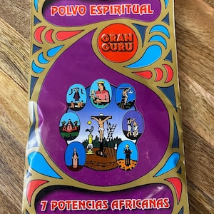 May include: A purple and gold package with the text "Polvo Espiritual Gran Guru" and "7 Potencias Africanas". The package features a circular design with images of religious figures and symbols.
