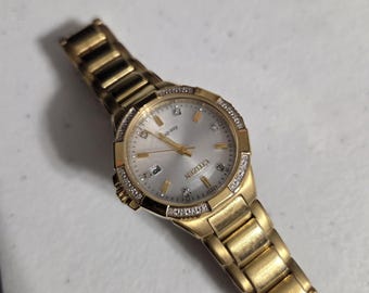 Citizen Riva Ladies Eco-Drive Diamond Gold-Tone Watch (Model EW2462-51A).