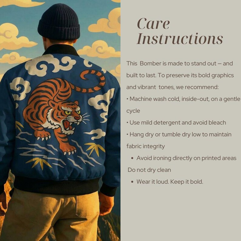 May include: A navy blue bomber jacket with a large orange tiger design on the back. The jacket has black trim and a blue and white cloud pattern. The text "Care Instructions" is visible. The jacket is part of a clothing collection.
