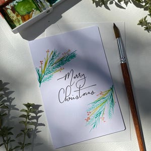 Tarjeta navideña con acuarela/Acuarela navideña con flores y verdes/Tarjeta navideña elegante