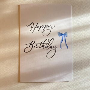 Cartão de feliz aniversário com laço/laço rosa fofo laço azul