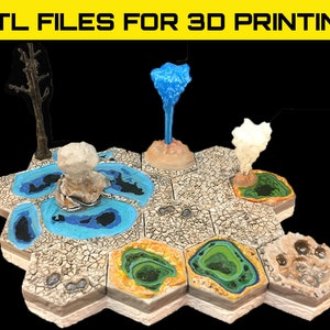May include: A set of six hexagonal tiles with different colored geysers and a small tree. The tiles are designed for 3D printing and are part of a set of STL files for 3D printing.