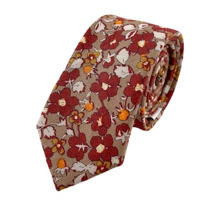 May include: A brown tie with a red floral pattern. The tie is made of a soft, cotton fabric and has a classic, slim design.