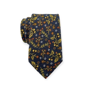 May include: A navy blue necktie with a repeating floral pattern in shades of gold, orange, and white. The tie is knotted and displayed against a white background. The floral design includes small flowers and leaves.