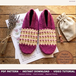 May include: A pair of knitted slippers in shades of fuchsia, cream, and olive green. The slippers feature a floral pattern and are displayed with a pattern chart, a small bag, and dried lavender. The image includes text that says "PDF Pattern - Instant Download - Video Tutorial".