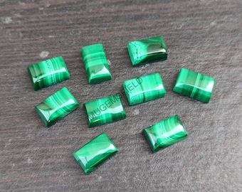 May include: Eight green malachite cabochons, cut in a rectangular shape, with a polished finish. The stones have a natural, striated pattern.