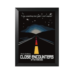 May include: Framed poster featuring a minimalist design of a road at night, with a colorful sky and the text "I saw something last night I can't explain." The title "CLOSE ENCOUNTERS OF THE THIRD KIND" is displayed below, with the director's name, Steven Spielberg.