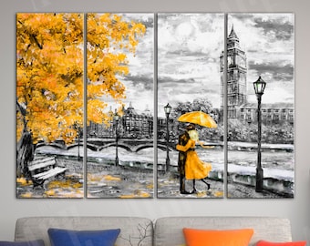 May include: A three-panel canvas print depicting a couple holding a yellow umbrella, standing on a bridge in a black and white cityscape with a yellow tree in the foreground. The cityscape includes a tall clock tower.